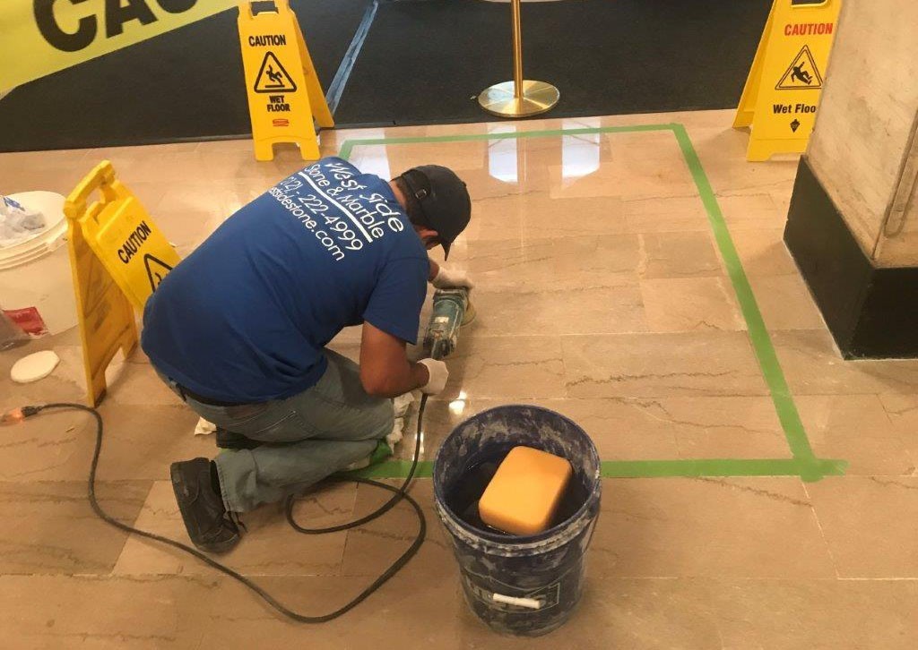 man using machinery to clean floor